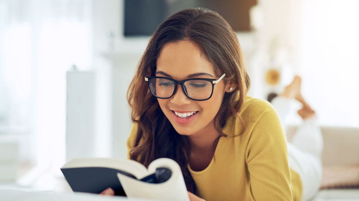 Woman reading a book at home