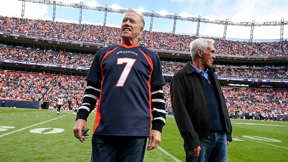 Denver Broncos John Elway stands on the field on 2022