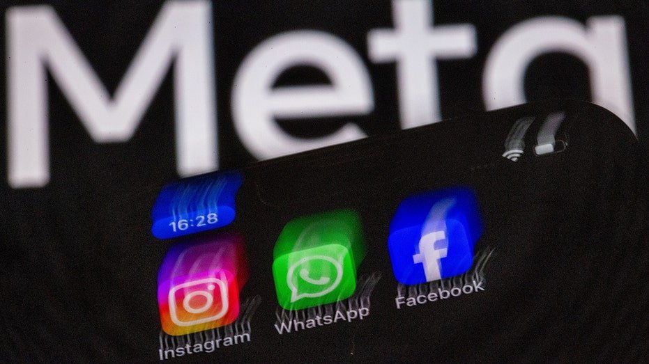 Meta apps including Instagram, WhatsApp and Facebook on a phone with Meta logo in the background