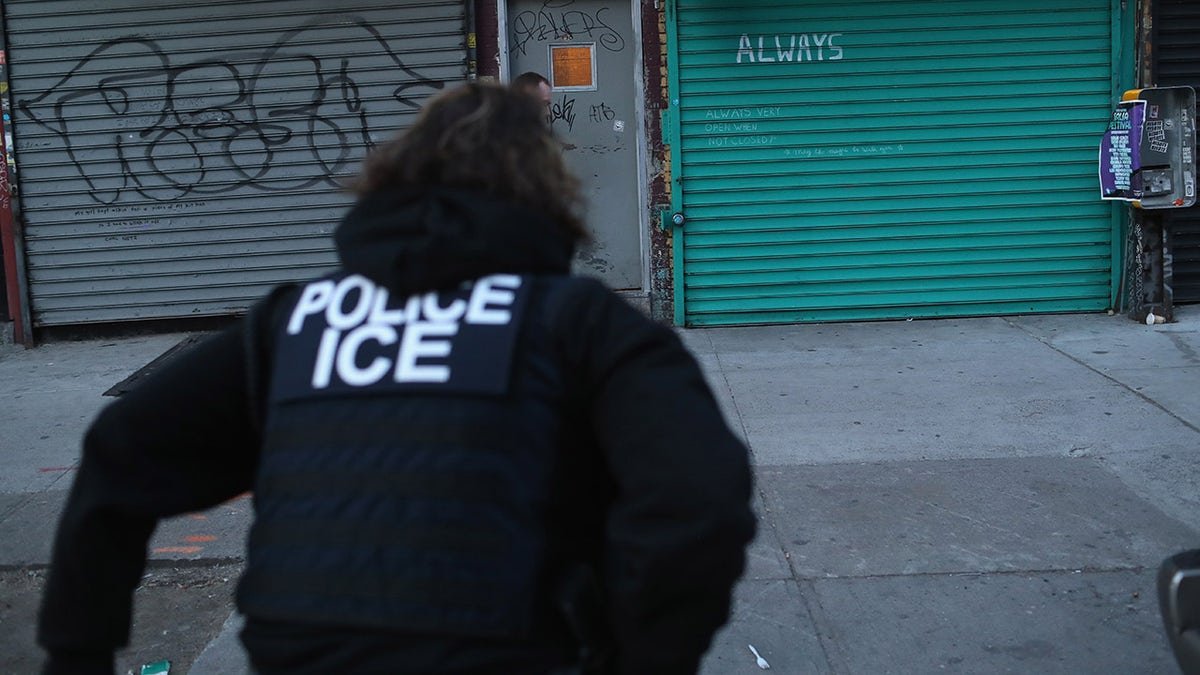 ICE agent seen from behind