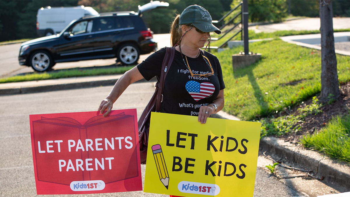 woman with protest signs