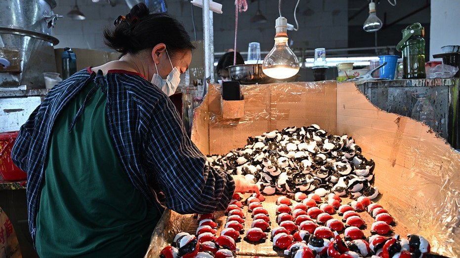 Employee works at a toy factory that makes solar toy's