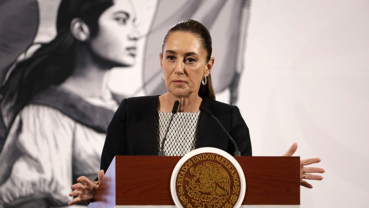 Mexican president speaking at podium while wearing black attire