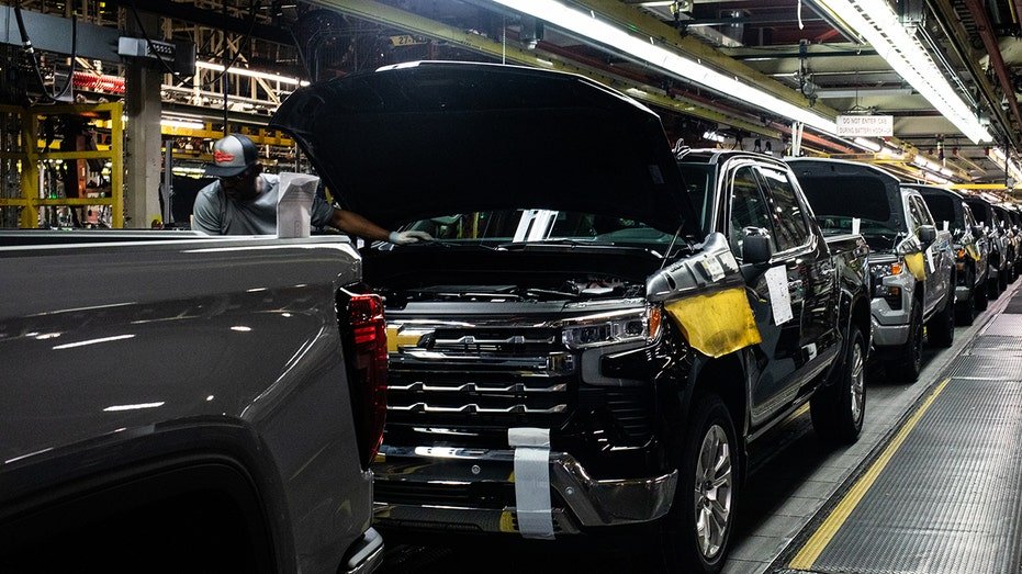 Vehicles on the trim assembly line with vehicle hood up