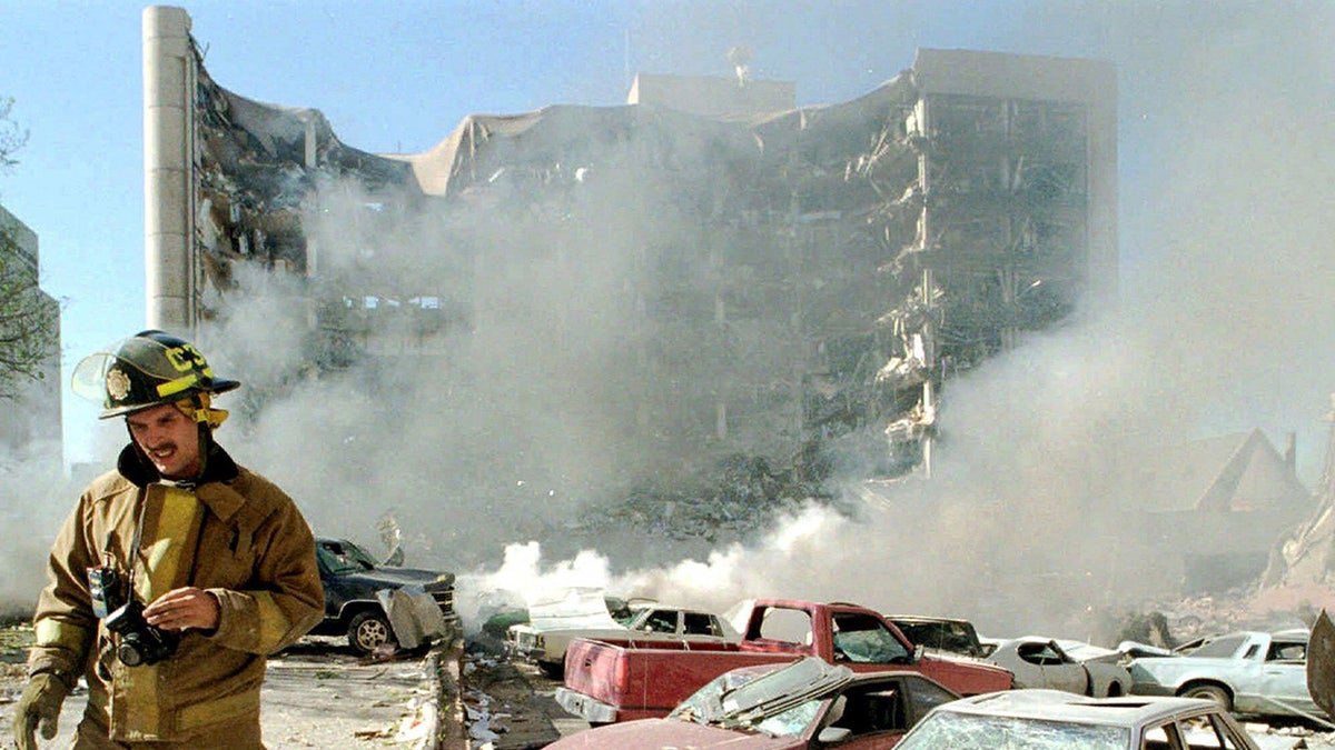 A firefighter standing next to the building where the Oklahoma City bombing took place.