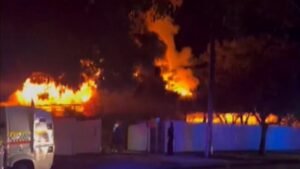 Woman charged after man burnt in house fire