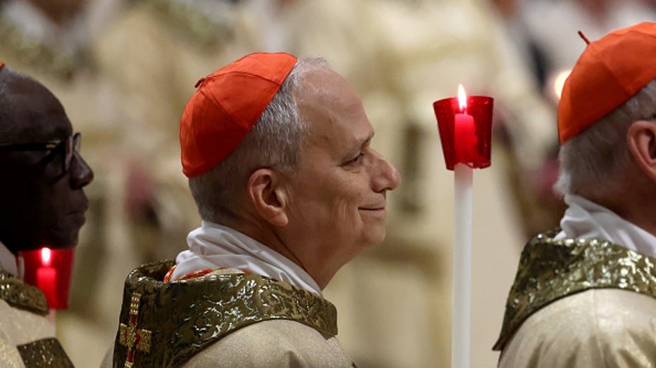 Cardinal Robert Francis Prevost holding candle during Easter mass