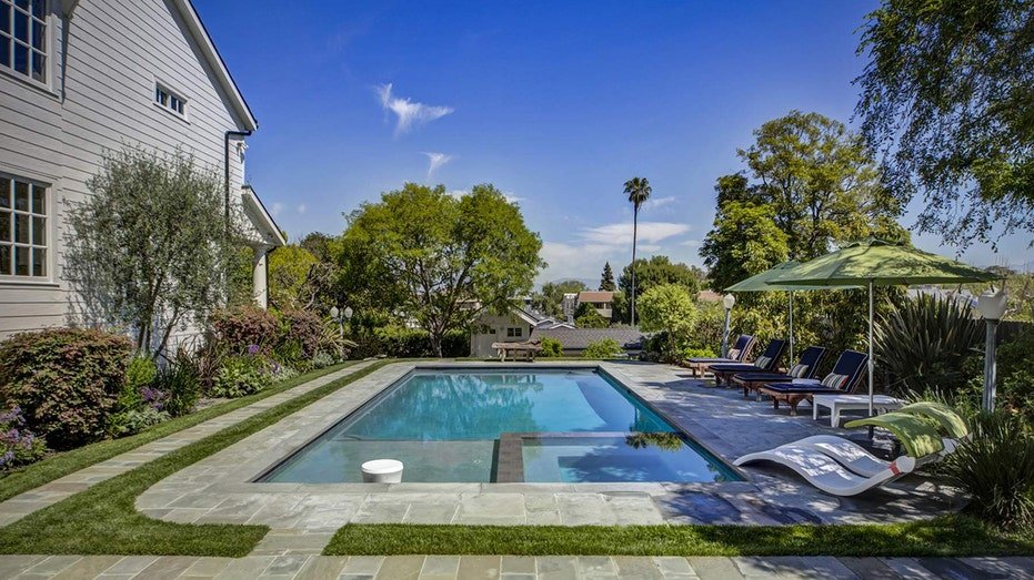 The yard also features a swimming pool.