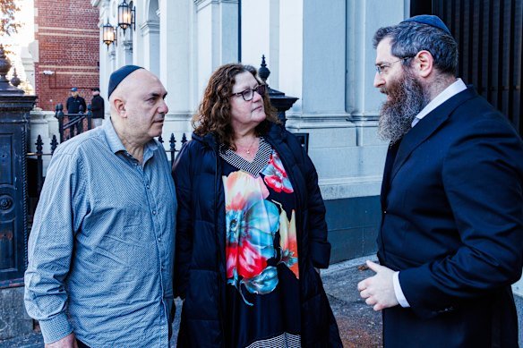 Synagogue president Danny Segal, his wife Jenny and Rabbi Dovid Gutnick outside the synagogue the morning after the attack.