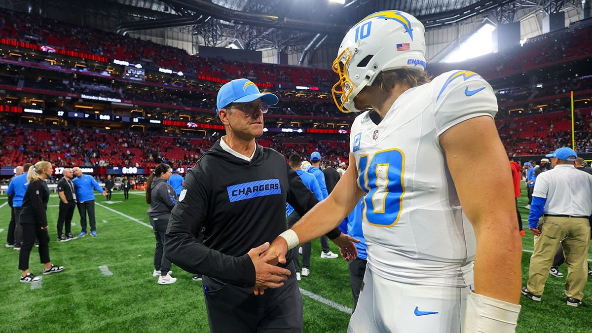 Jim Harbaugh shakes Justin Herbert's hand