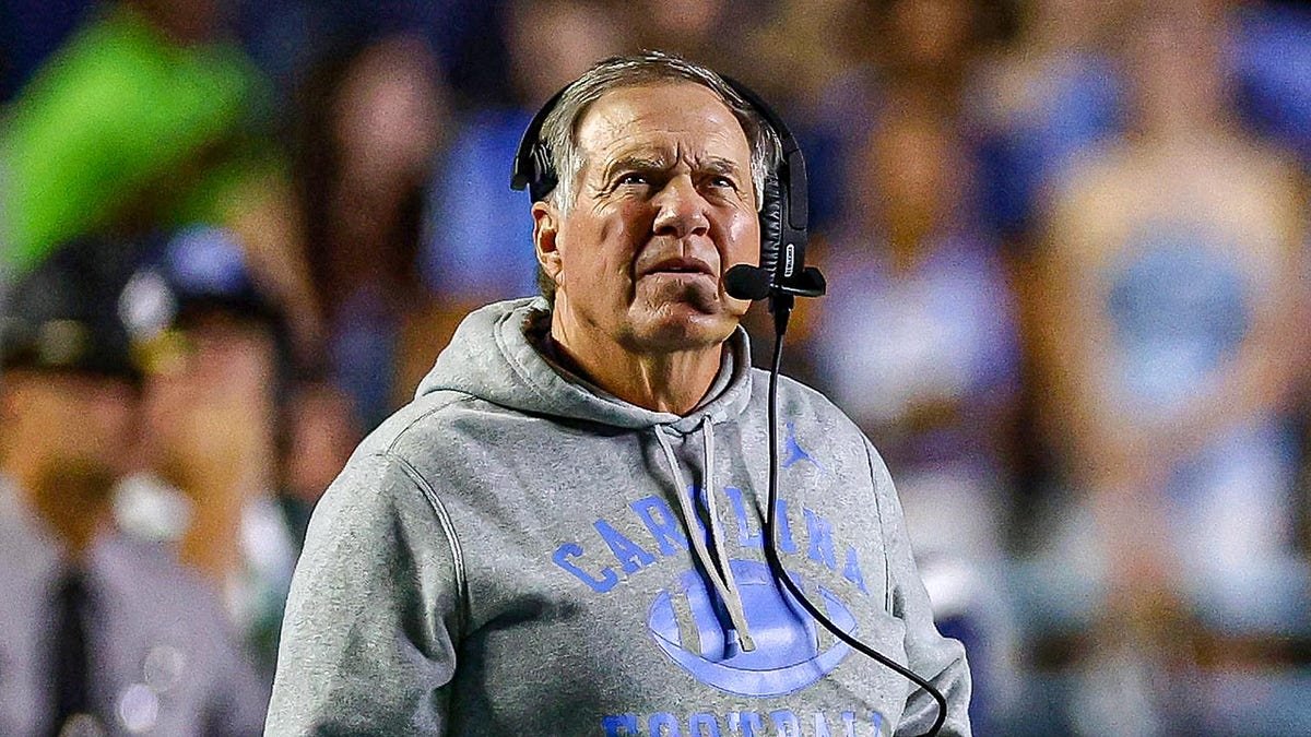 Bill Belichick looks up on field during UNC game