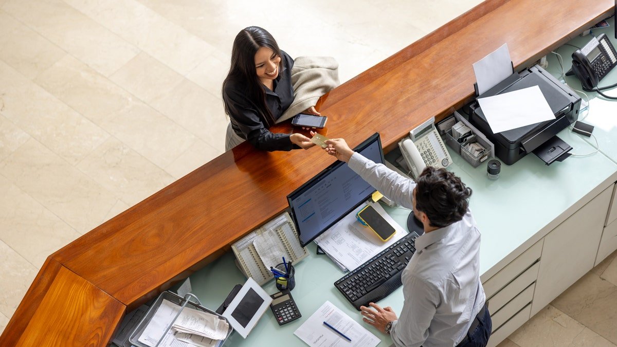 Woman checking out of hotel