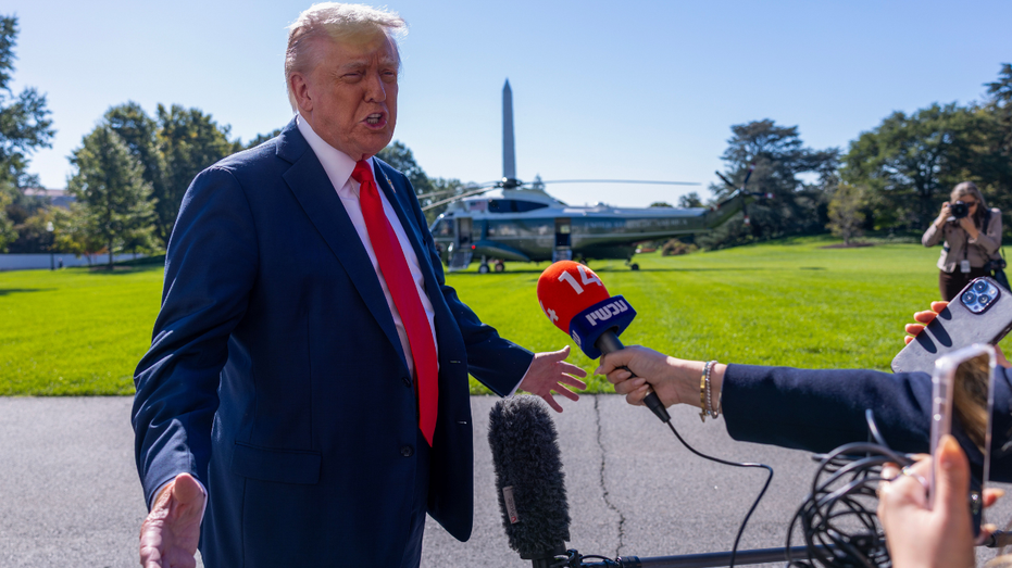U.S. President Donald Trump talks to the media before heading to Marine One on the south lawn of the White House