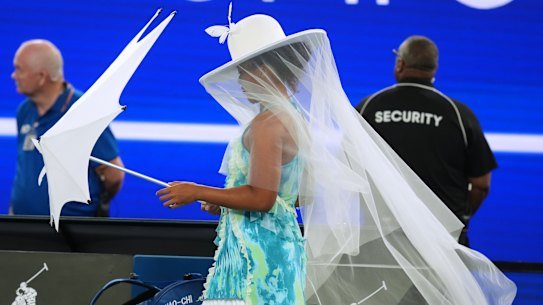 Naomi Osaka walks onto Rod Laver Arena.