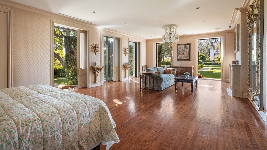 The spacious primary bedroom features a fireplace and access to the outside.