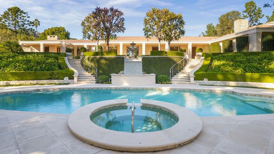 The backyard also features an oval swimming pool.
