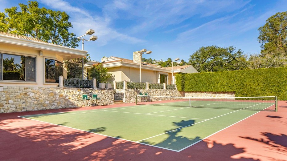 A regulation tennis court with shaded seating can also be found on the property.