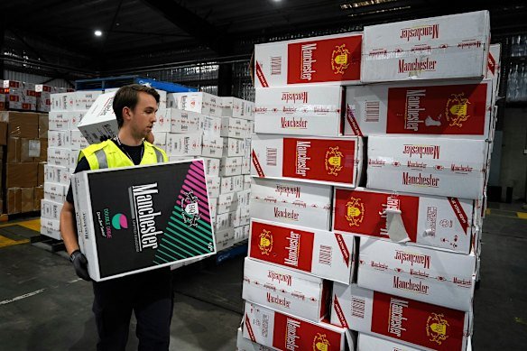 An Australian Border Force officer checks a stash of illegal cigarette imports in Melbourne.