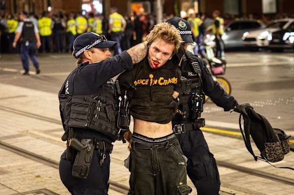 A protester with a bloodied mouth after being arrested.