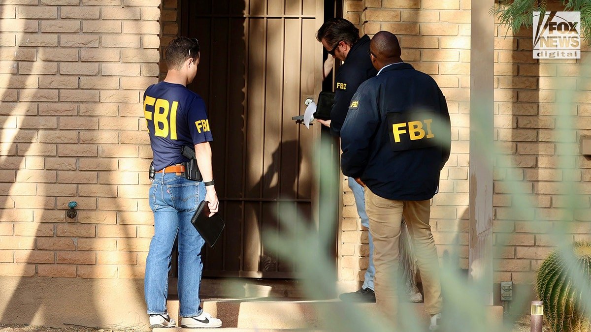 FBI agents canvassing a residential neighborhood near Nancy Guthrie's home.