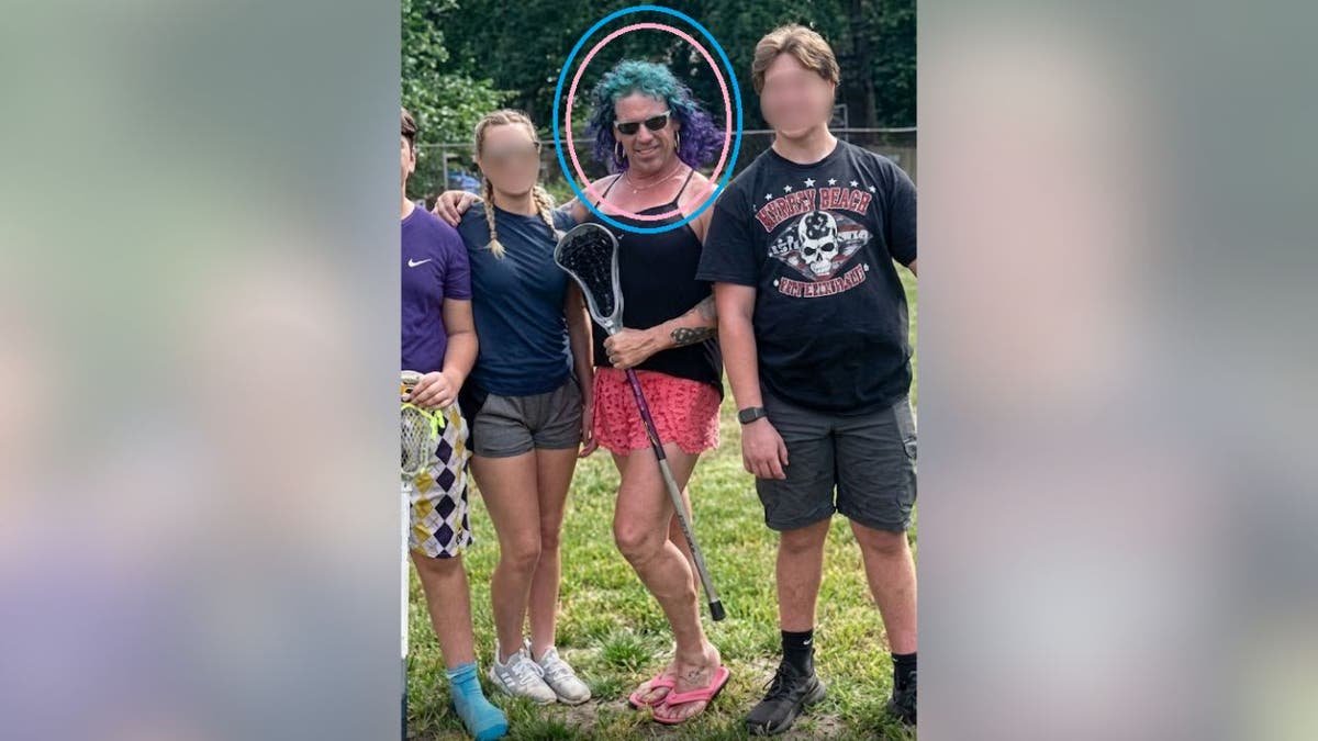 Robert Dorgan standing outdoors with children in an undated photo related to the Rhode Island ice rink shooting.