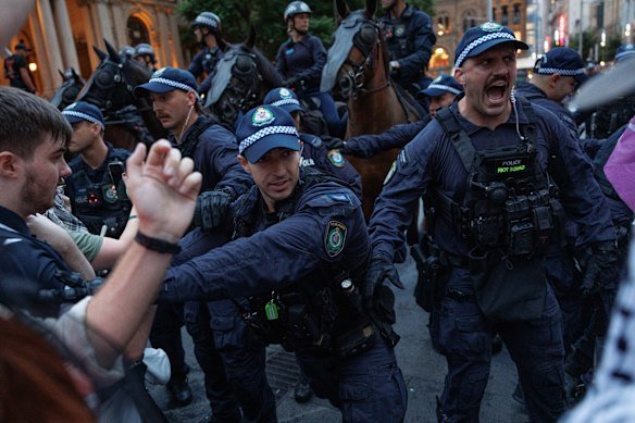 Police fight to control the crowd at Town Hall on Monday night.