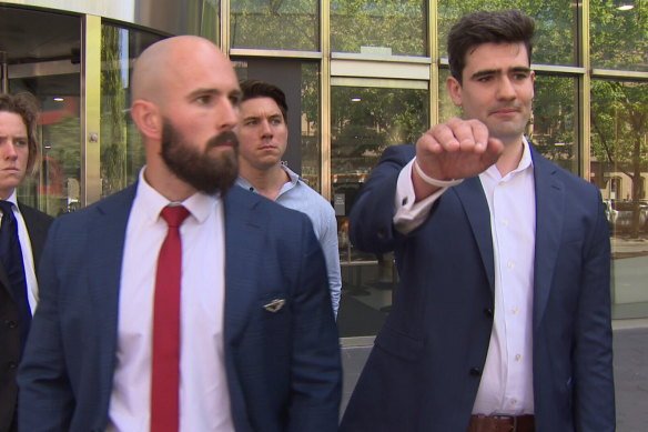 Thomas Sewell and Jacob Hersant outside Victoria’s County Court performing the illegal gesture.