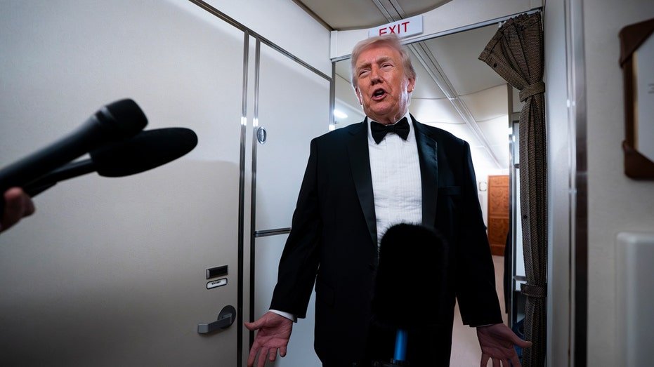 Donald Trump speaks to reporters aboard air force one