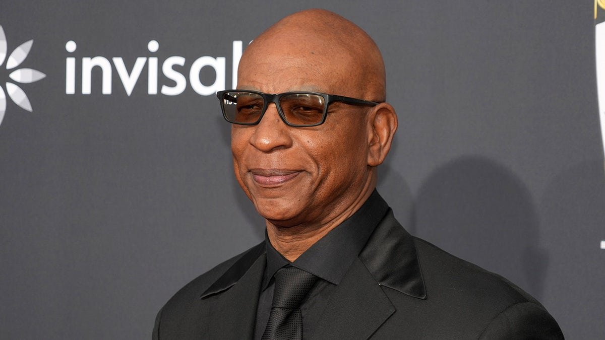 Eric Dickerson looks on