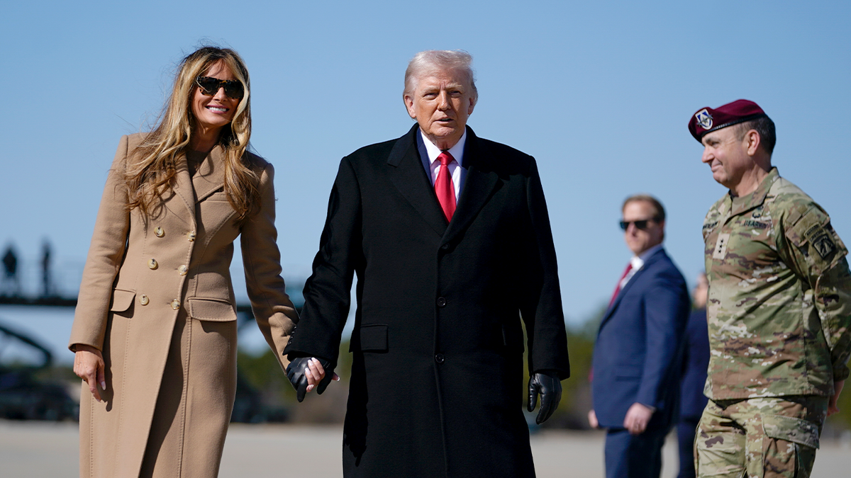 President Trump and first lady Melania Trump walk on tarmac 
