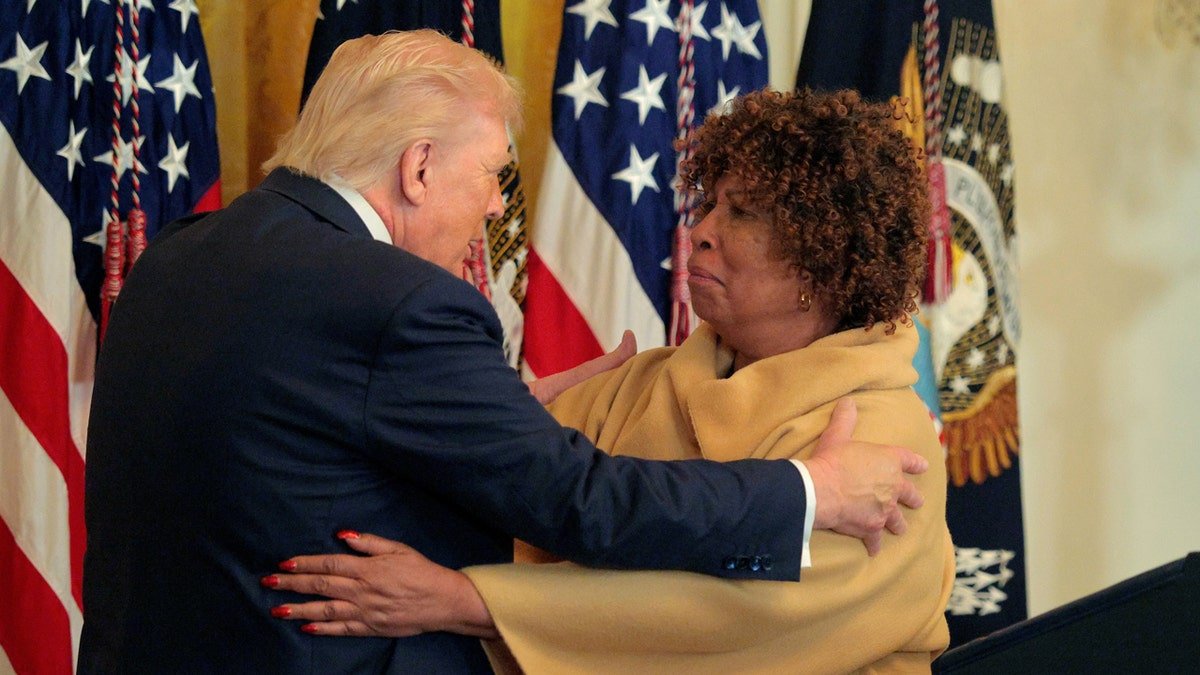 President Donald Trump embraces DC resident Felicia Cook