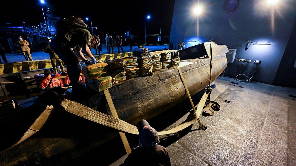 Officials inspect a seized narco sub