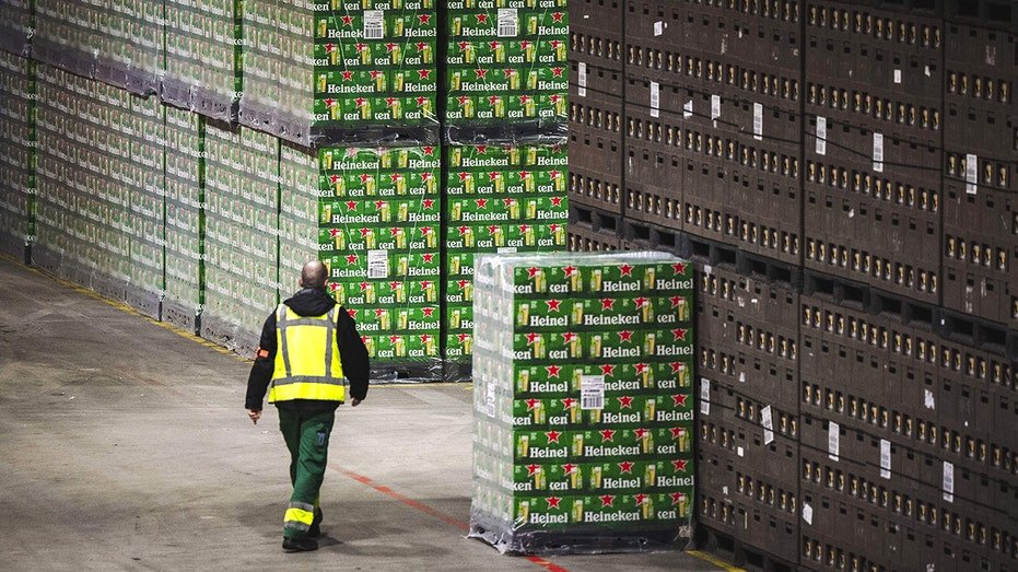 Heineken employee walking crates