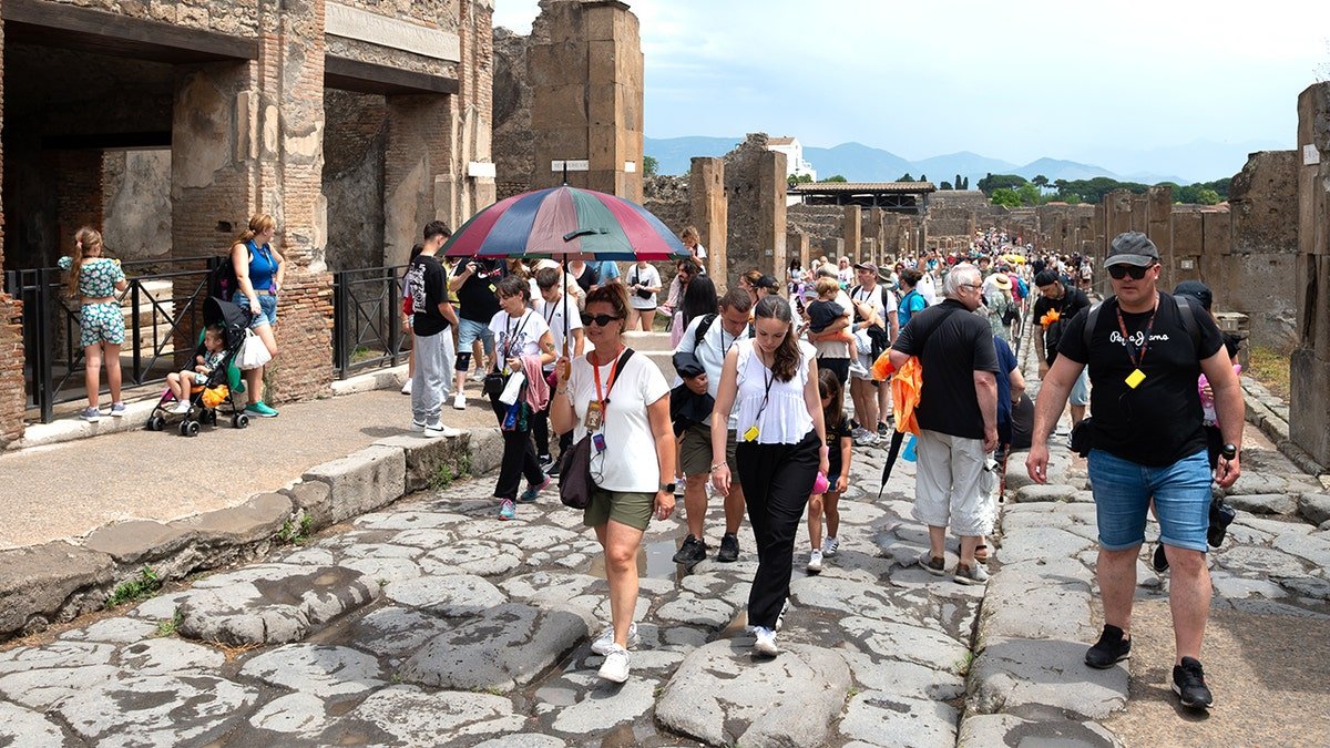 Tourists walking through Pompeii in summer