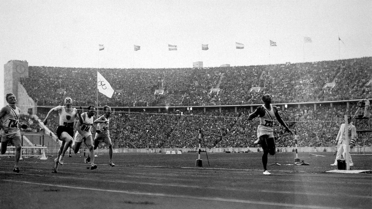 Jesse Owens winning the 100 meters in 1936
