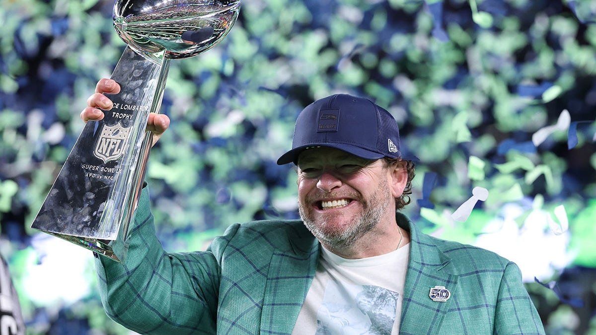John Schneider holds Super Bowl trophy