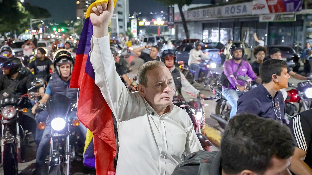 A recently freed opposition figure speaks with families gathered outside a high-security detention facility in Caracas.