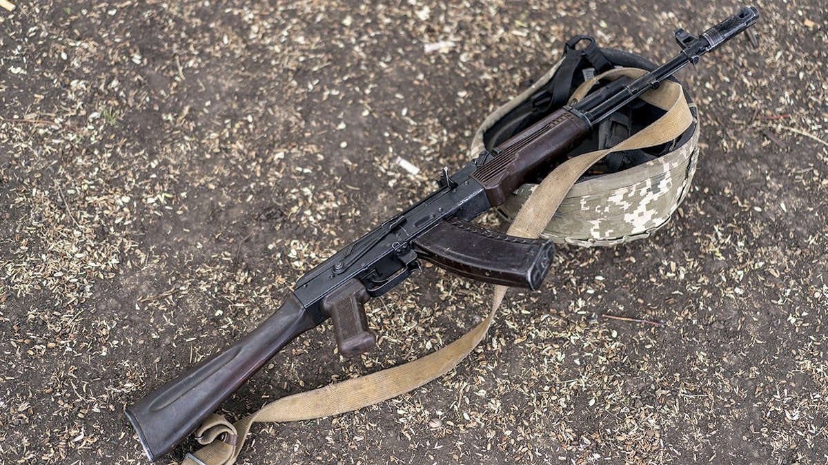 Kalashnikov rifle and helmet belonging to Ukrainian soldier
