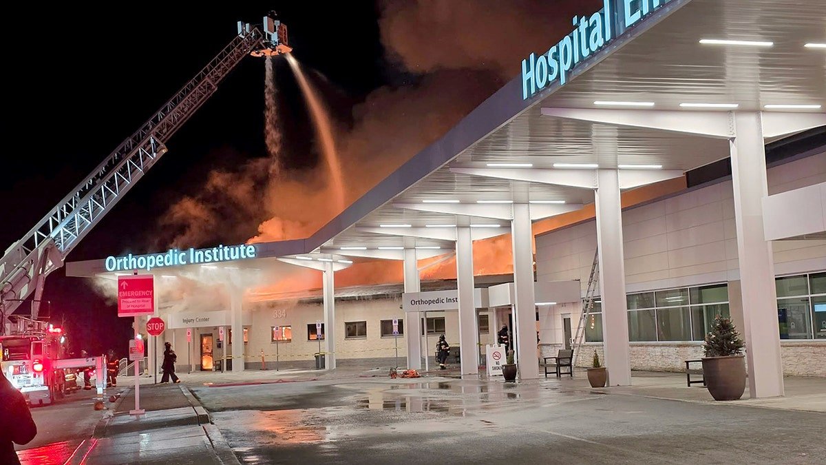 A shot of the Lehigh Valley Hospital Orthopedic Institute with a fire hose putting out a fire.