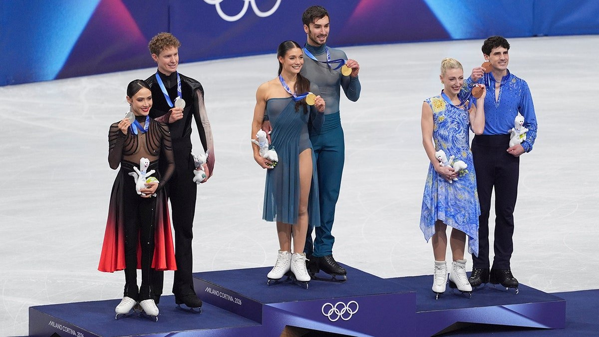 Medalists pose at the podium