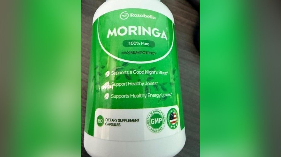 green and white bottle with "moringa" printed on it
