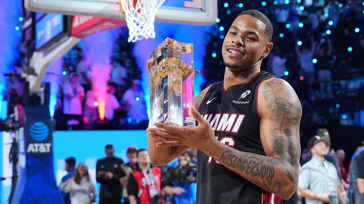 Keshad Johnson holds the trophy