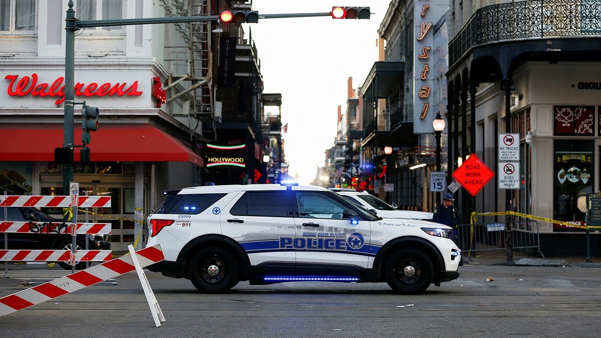 A New Orleans police vehicle blocks the entrance to Bourbon Street.