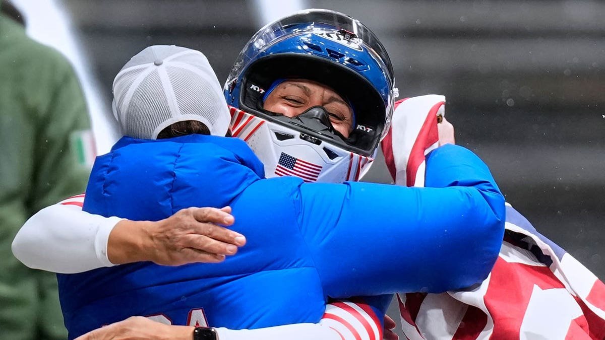 Elana Meyers Taylor celebrates with her coaches