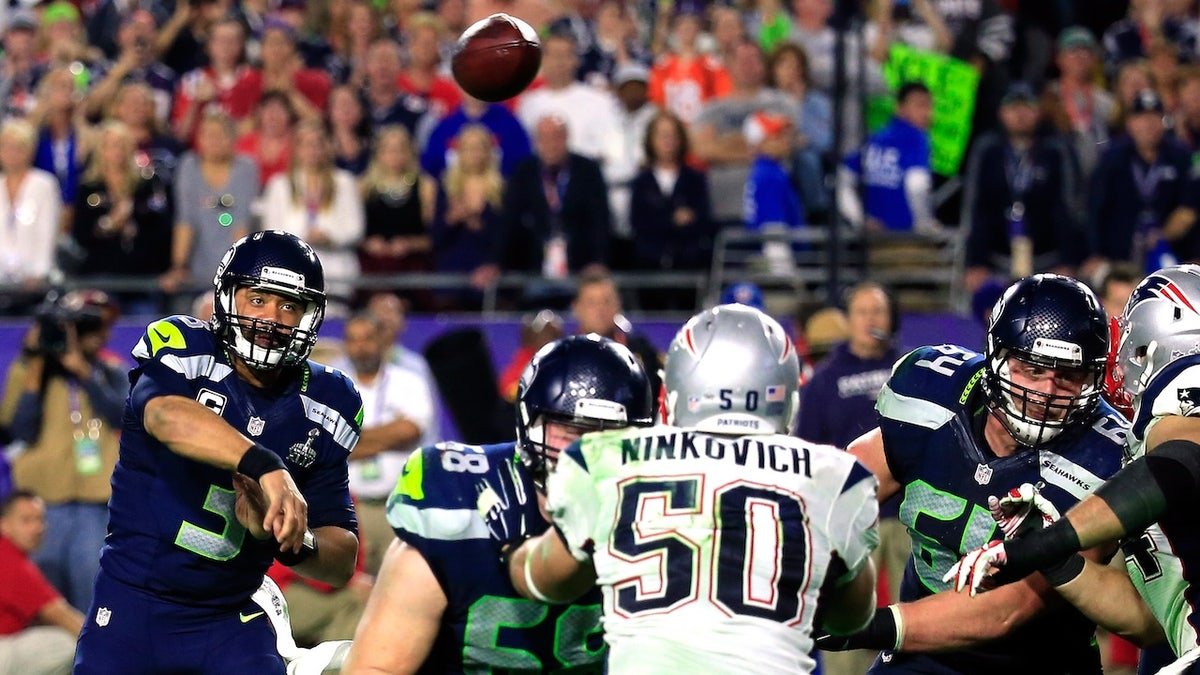 Russell Wilson has a pass intercepted by Malcolm Butler late in the fourth quarter during Super Bowl XLIX at University of Phoenix Stadium on Feb. 1, 2015 in Glendale, Arizona. 