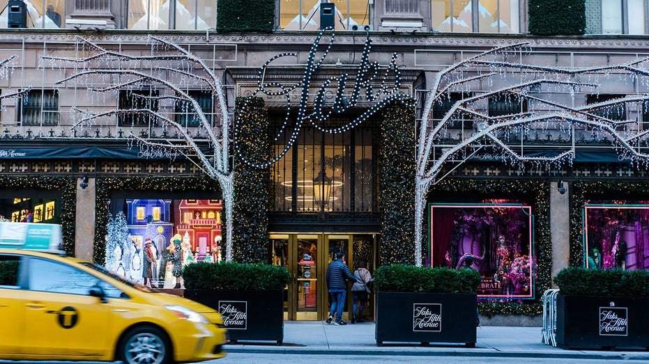 Shoppers enter the Saks Fifth Avenue store on Fifth Avenue in New York.