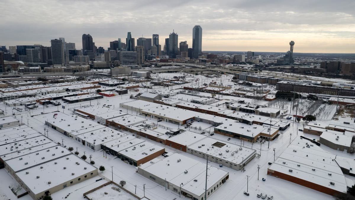 Aerial view of snow-covered buildings and streets in Dallas, Texas, during a winter storm.