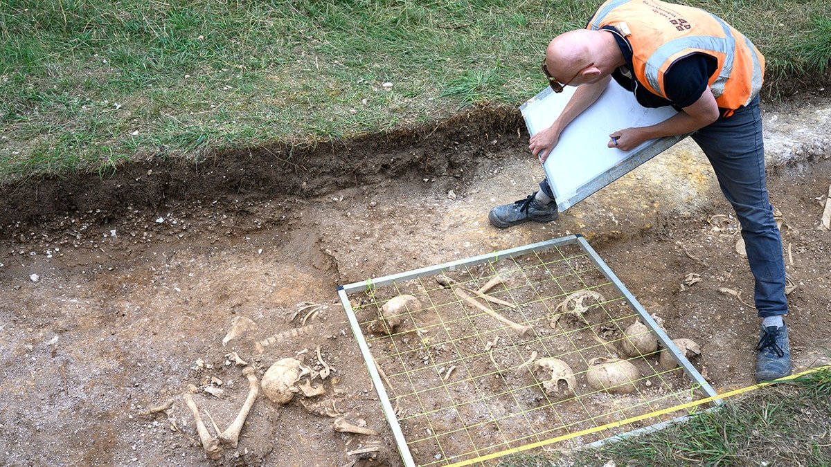 Archaeologist sifting dirt at burial