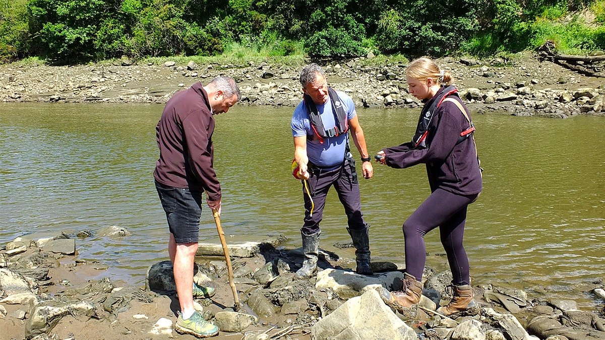 Archaeologists talking with each other at site