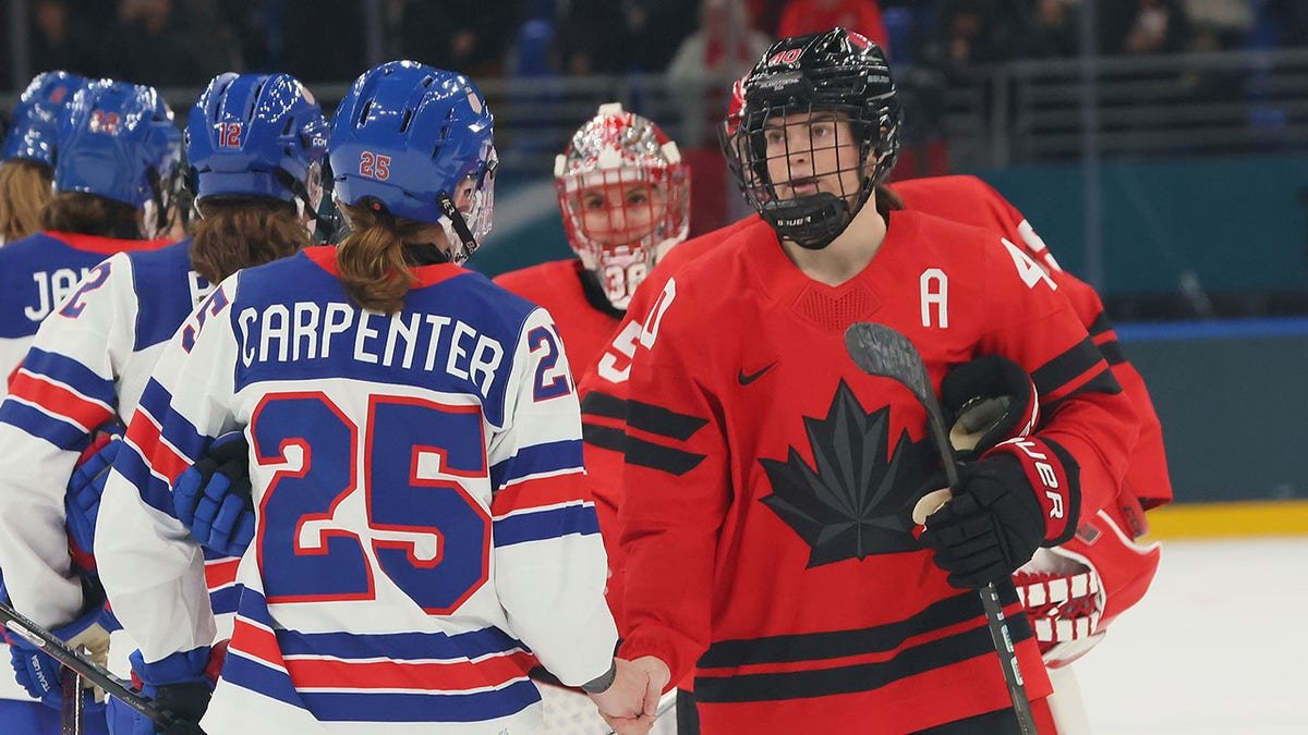 Team USA and Canada shake hands